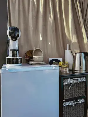 a blue refrigerator next to a table with a blender at A little corner of paradise in Molde