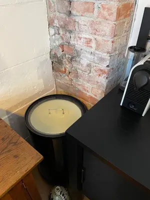 a toilet in a room with a brick wall at Ålesund Central Apartment in Ålesund