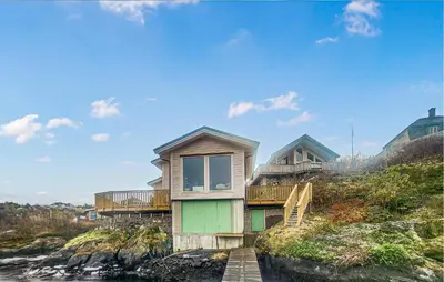 a house on top of a hill near the water at 3 Bedroom Awesome Home In Rossland in Rossland