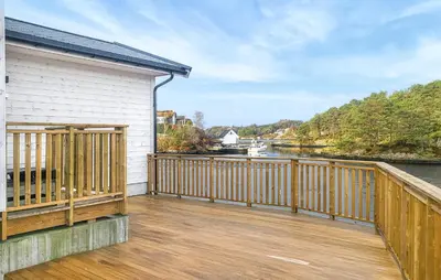 a large wooden deck with a view of a river at 3 Bedroom Awesome Home In Rossland in Rossland