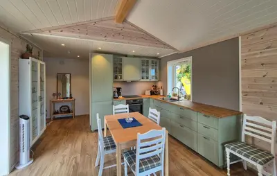 a kitchen with a table and chairs in a room at 3 Bedroom Awesome Home In Rossland in Rossland