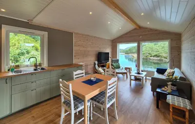 a kitchen and dining room with a table and chairs at 3 Bedroom Awesome Home In Rossland in Rossland