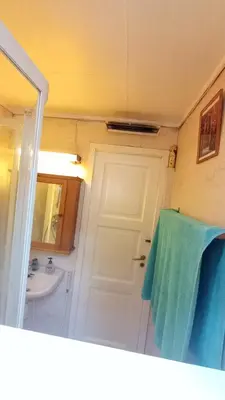 a bathroom with a white door and a sink at Room2B in Bergen