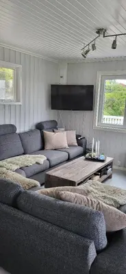 a living room with two couches and a table at Cottage in Hellesøy, Øygarden in Hellesøy