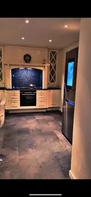 a kitchen with a stove and a refrigerator at Helt hus leies ut under fiskeri messe 2025 in Trondheim