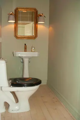 a bathroom with a toilet and a sink and a mirror at Villa Solås in Lillehammer
