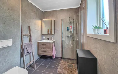 a bathroom with a shower and a sink at Amazing Home In Bremnes With Wifi in Bremnes
