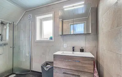 a bathroom with a sink and a shower at Amazing Home In Bremnes With Wifi in Bremnes