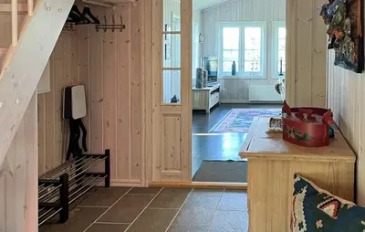 a living room with a staircase and a room with a phone at Gorgeous Home In Rauland With Sauna in Rauland