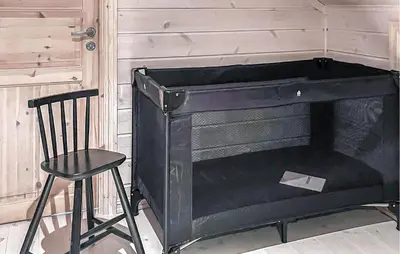 a black piano and a chair next to a wall at Gorgeous Home In Rauland With Sauna in Rauland
