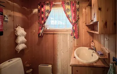 a bathroom with a sink and a toilet and a window at Beautiful Home In Sjusjøen With Sauna in Sjusjøen