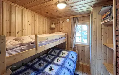 a bedroom with a bunk bed in a wooden cabin at Beautiful Home In Sjusjøen With Sauna in Sjusjøen