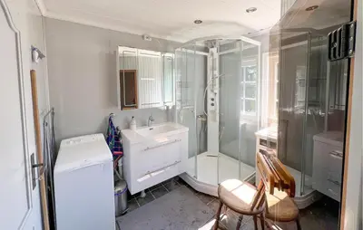 a white bathroom with a shower and a sink at Beautiful Home In Sjusjøen With Sauna in Sjusjøen
