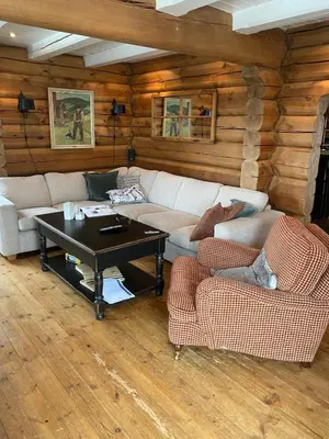 a living room with two couches and a coffee table at Stor velutstyrt laftehytte med usjenert uteplass, flott utsikt og Jacuzzi in Eggedal