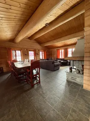 a living room with a table and chairs and a couch at Lomtjern in Beitostøl