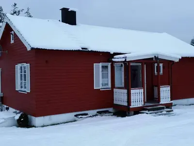 a red house with snow on the roof at 6 person holiday home in Osen
