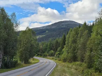an empty road with a mountain in the background at 6 person holiday home in Osen