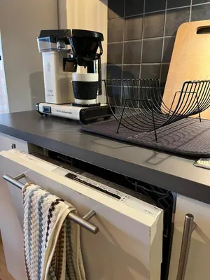 a kitchen counter with a coffee maker on top of it at Exclusive flat with amazing view over the fjord in Trondheim