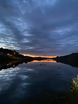 a view of a river at night at Haraldseidvågen gjestgjevarstad in Skjold