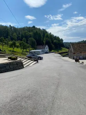 an empty road with a car parked on the side at Haraldseidvågen gjestgjevarstad in Skjold