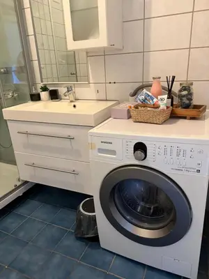 a washing machine in a bathroom with a sink at Mai Tran in Gjøvik