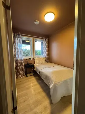 a bedroom with two beds and a window at Modern apartment, large terrace free parking and Wallbox in Ytterland