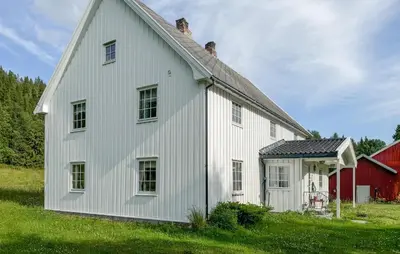 a white house with a red barn at Stunning Home In Engerdal With Wifi in Nymoen