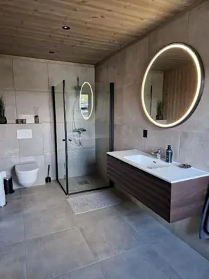 a bathroom with a tub and a sink and a shower at Ny hytte med panoramautsikt in Hjartdal