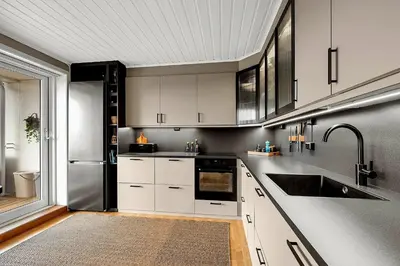a kitchen with white cabinets and a stainless steel refrigerator at Private Room in a shared Apartment with Mountain Views & Greenery in Trondheim