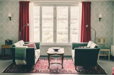 a living room with two couches and a window at Steien Hotel in Alvdal