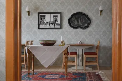 a dining room with a table with a table cloth on it at Steien Hotel in Alvdal