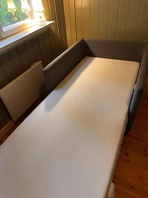 a bed in a room next to a window at Charming family house near Kvitfjell in Ringebu