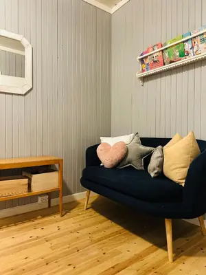 a blue couch sitting in a living room at Charming family house near Kvitfjell in Ringebu