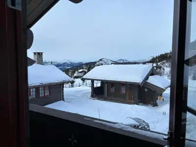 a view from a window of snow covered buildings at Sleepover in the mountains in Hjartdal