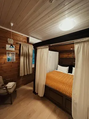 a bedroom with a bed in a log cabin at Snerting Ranch Hotel - Comfty and modern Log House in Stokkan