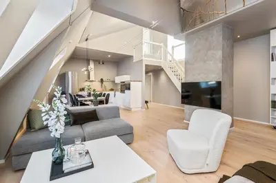 a living room with a couch and a tv at Two bedroom penthouse with large living room and rooftop in the city centre of Trondheim in Trondheim