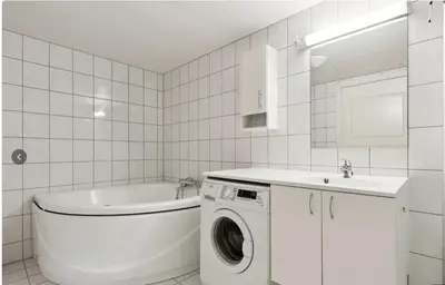 a white bathroom with a washing machine and a sink at Family Friends, 3 Bedroom Apartment With Terrace in Beitostøl