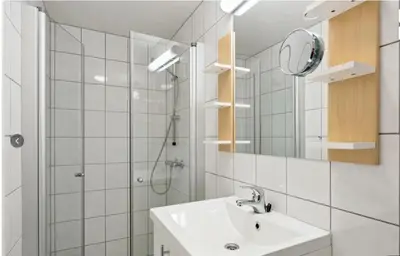 a bathroom with a sink and a shower and a mirror at Family Friends, 3 Bedroom Apartment With Terrace in Beitostøl