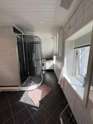 a large bathroom with a shower and a window at In the middle of Bergen City in a real Bergenshus from the 18th Century in Bergen