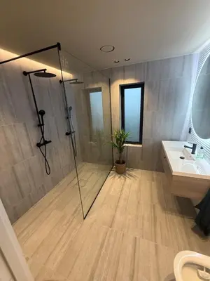 a bathroom with a shower and a sink at Modern detached house with a view in Arefjord