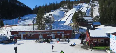a group of people standing in the snow near a ski lodge at Spacious 3-Bedroom Apartment with Balcony and Free Parking Orkland near Trondheim in Fannrem