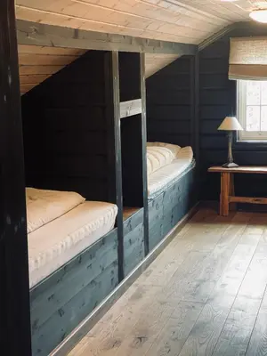 two bunk beds in a room with a table at No71 Golsfjellet in Golsfjellet