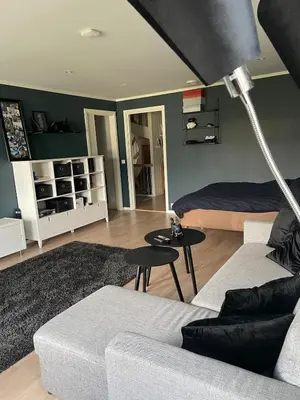 a living room with a couch and a bed at Casa Oyen in Ålesund