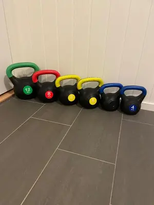 a group of four toy trains sitting on the floor at Casa Oyen in Ålesund