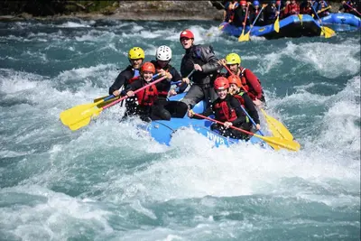 a group of people are rafting on a river at Waterfall Retreat in Sel