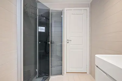 a shower with a glass door in a bathroom at Authentic Bergen Charm in Famous Neighborhood in Bergen