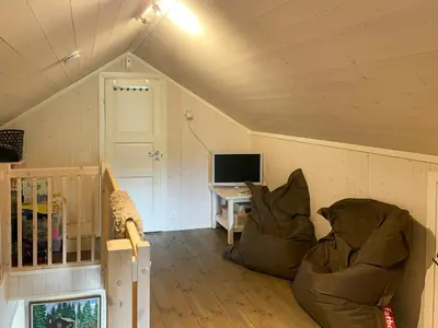 a living room with two chairs and a television at Cabin With Panoramic Views In Hafjell in Øyer