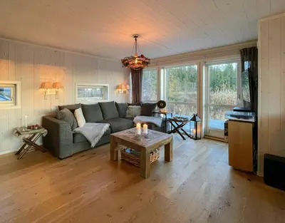 a living room with a couch and a table at Cabin With Panoramic Views In Hafjell in Øyer