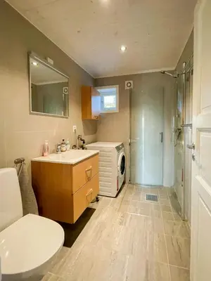 a bathroom with a sink and a washing machine at Cabin With Panoramic Views In Hafjell in Øyer