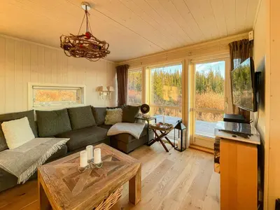 a living room with a couch and a table at Cabin With Panoramic Views In Hafjell in Øyer